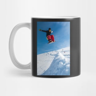 Snowboarder jumping against blue sky Mug